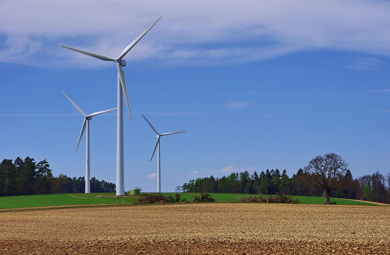Wind turbines against sunset